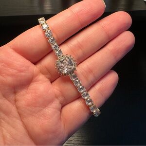 Sparkly tennis-style bracelet with halo center stone